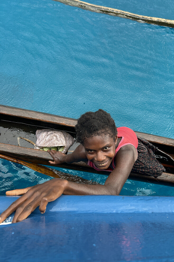 Residents of Tungelo Island in their traditional dugout canoes, New Ireland province, Papua New Guinea