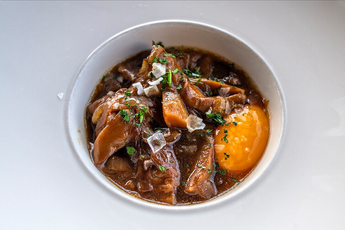 Sautéed mushrooms with tempered egg in Bokado Restaurant of Mikel Santamaria renowned Michelin starry chef on botton of Urgull area. San Sebastian Donostia Historic centre. Guipuzcoa. Basque Country. Spain. Europe