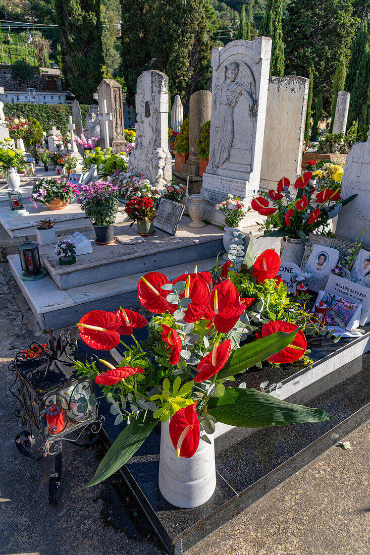 Flowers decorate the graves in a cemetery in Anacapri on the island of Capri, Italy.