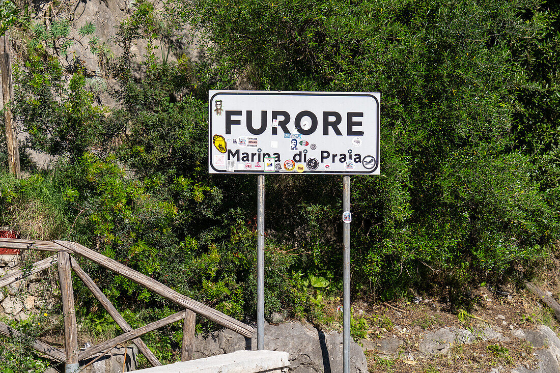 Road sign for the commune of Furore on the Amalfi Coast in Italy. Vandalized with stickers.