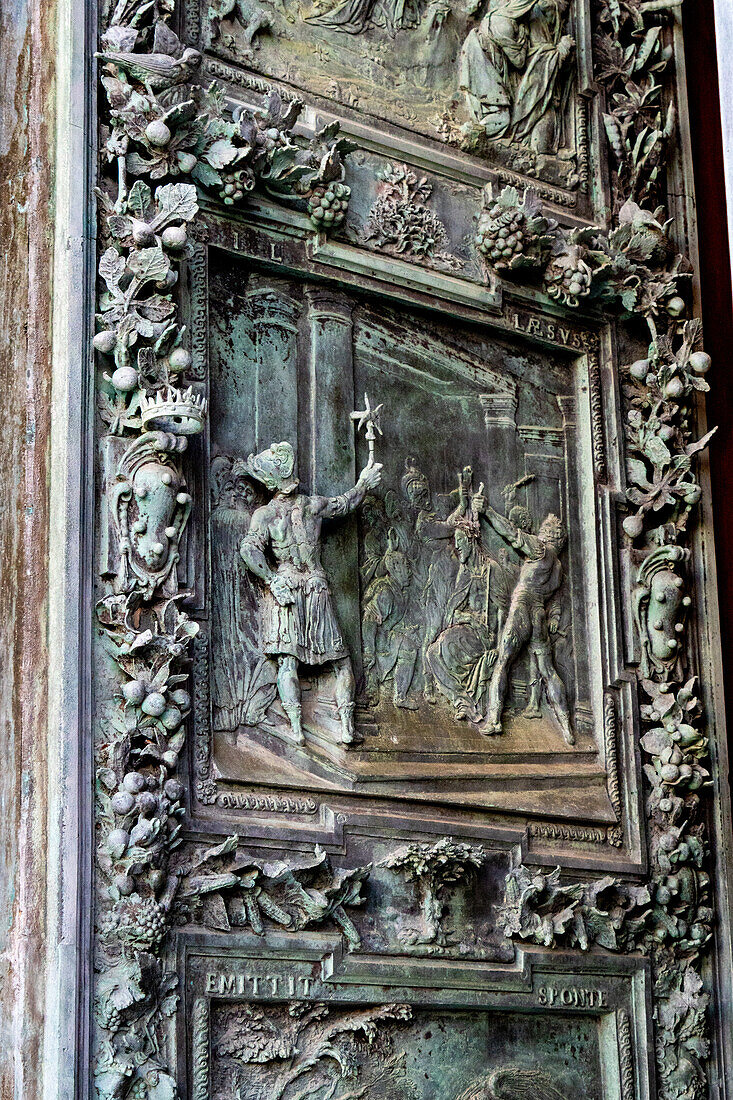 Detail of the right portal door of the Duomo of Pisa. Cast in bronze in 1605 by Giambologna. Pisa, Italy. Depicted is the mocking of Christ with the crown of thorns.