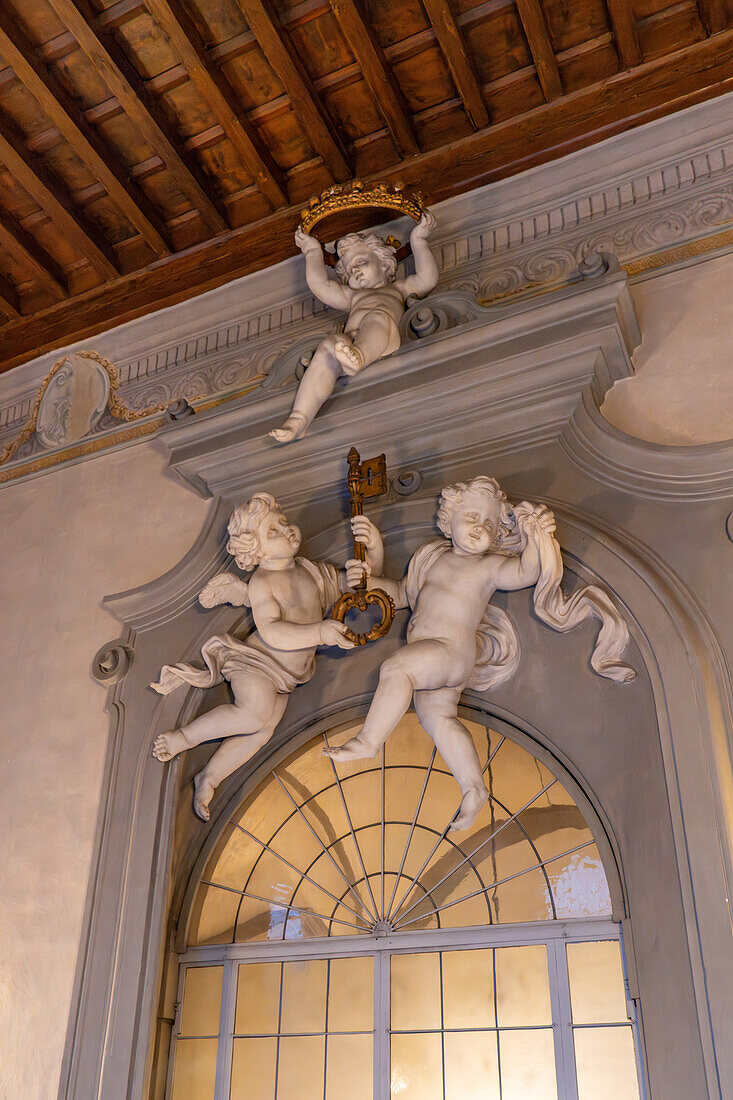 Cherubs with elements of the Riccardi coat of arms in the Palazzo Medici Riccardi, Florence, Italy. The key and crown are components of the Riccardi family crest.