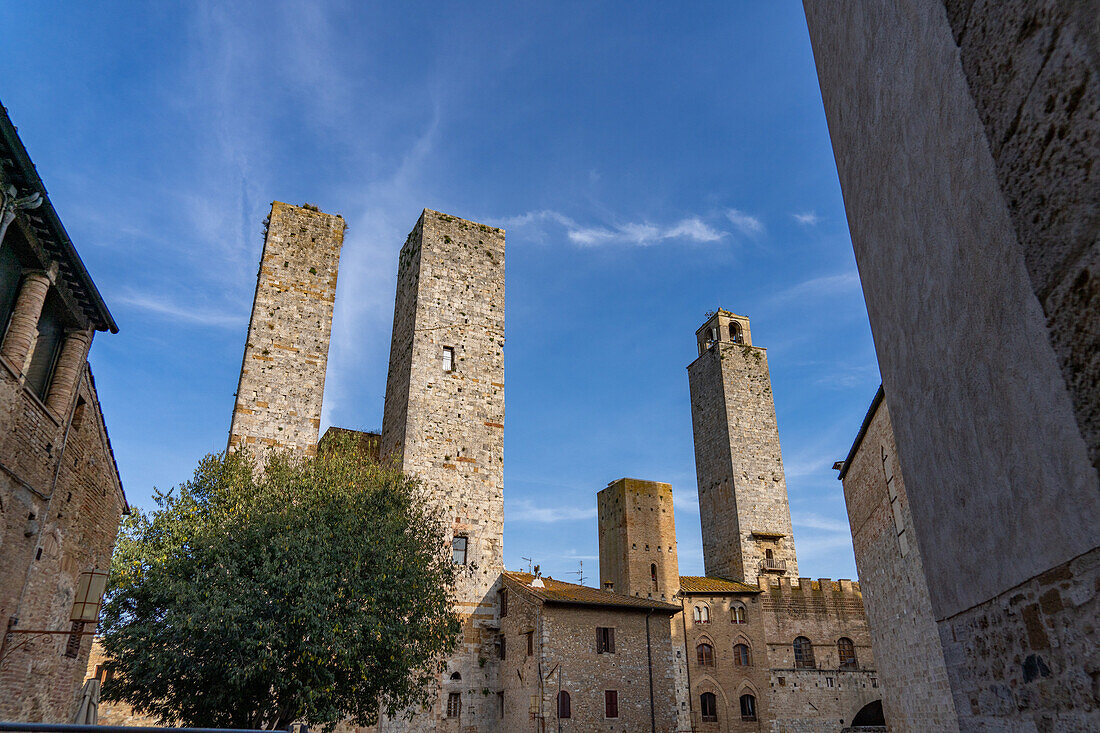 The twin Salvucci Towers in the Piazza della Erbe in the medieval city of San Gimignano, Italy. At right are the Torre Chigi and the Torre Rognosa.