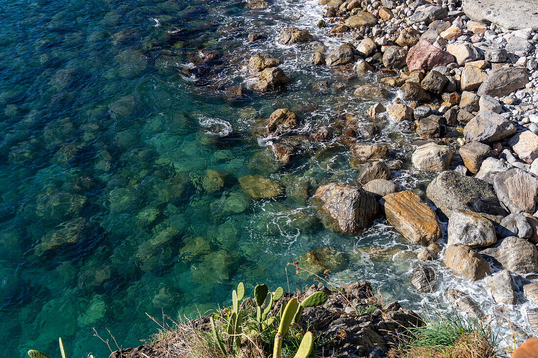 The clear waters of the Lingurian Sea on the rocks at Monterosso al Mare, Cinque Terre, Italy.