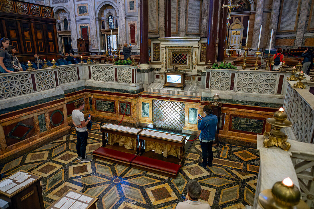 Tourists visiting the tomb of St. Paul in the Basilica of St. Paul Outside the Walls, Rome, Italy.