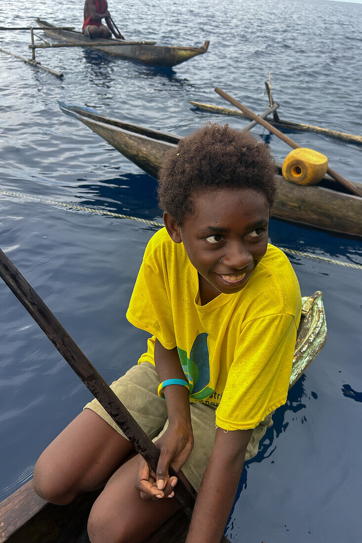 Residents of New Hanover island in their traditional dugout canoes, New Ireland province, Papua New Guinea