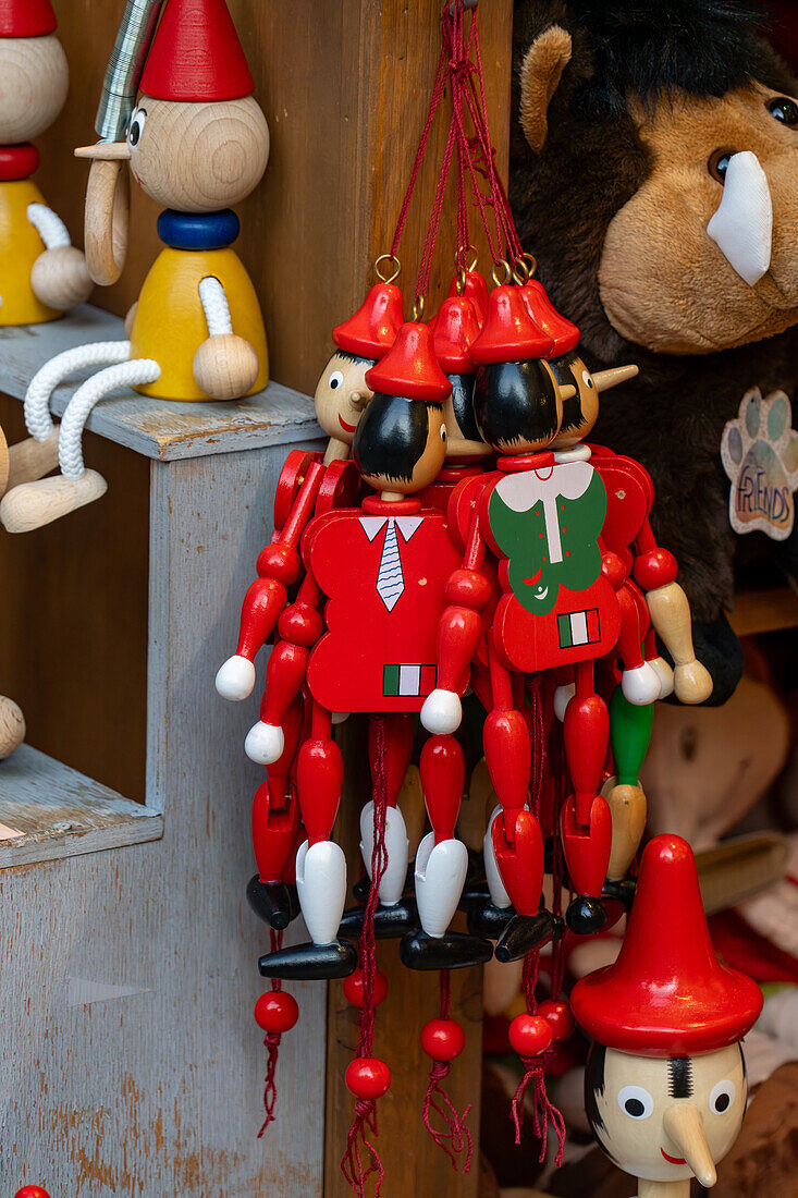 Wooden Pinocchio dolls for sale in a shop on Via San Giovanni in the medieval city of San Gimignano, Italy.