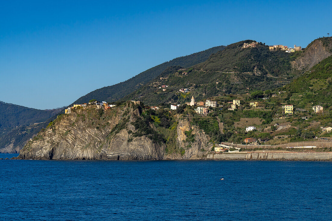 The small village of Corniglia in Cinque Terre perched on the cliff above the Ligurian Sea in Italy.