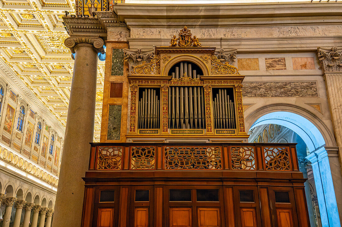 An ornate antique pipe organ in the transept of the Basilica of St. Paul Outside the Walls, Rome, Italy.