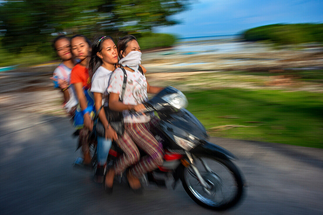 Local people, fanny many people driving a motorcyce in Sipaway Island, San Carlos City, Negros Occidental, Philippines