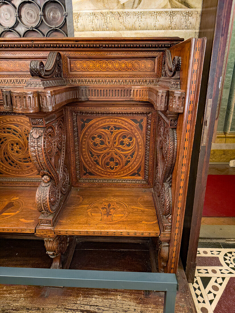 Carved wooden stalls with inlaid wood designs in the Magi Chapel in the Palazzo Medici Riccardi in Florence, Italy.