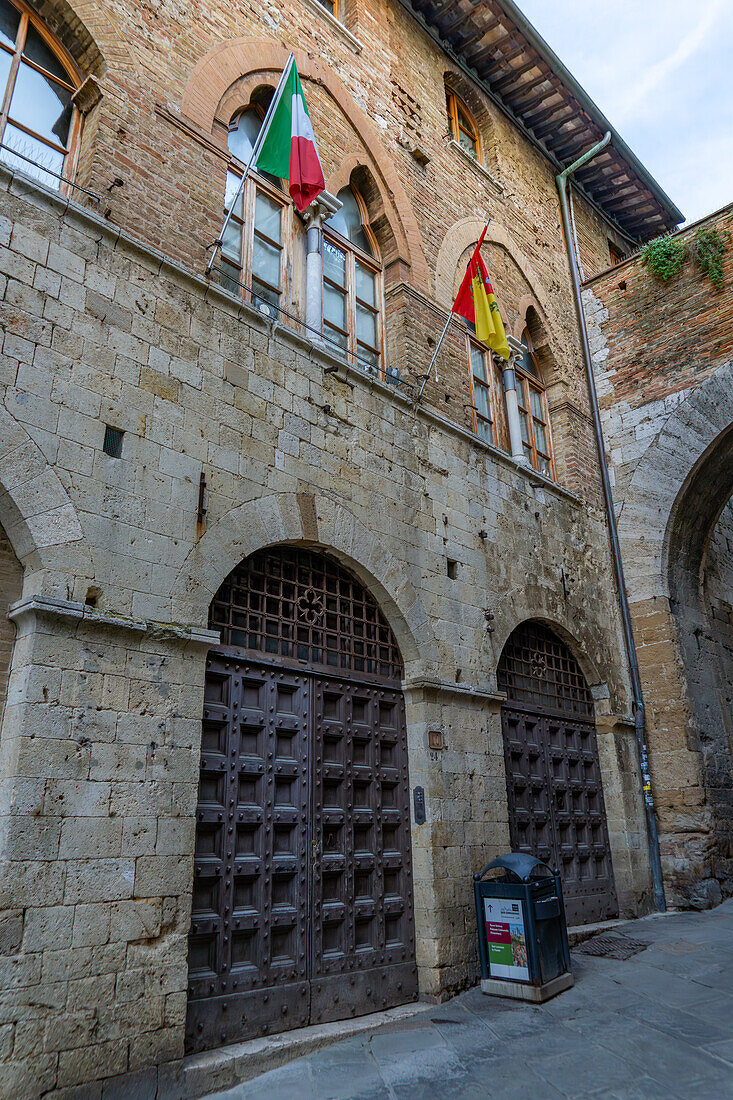 The facade of the 13th Century Chancellery Palace on Via San Matteo in the medieval city of San Gimignano, Italy.