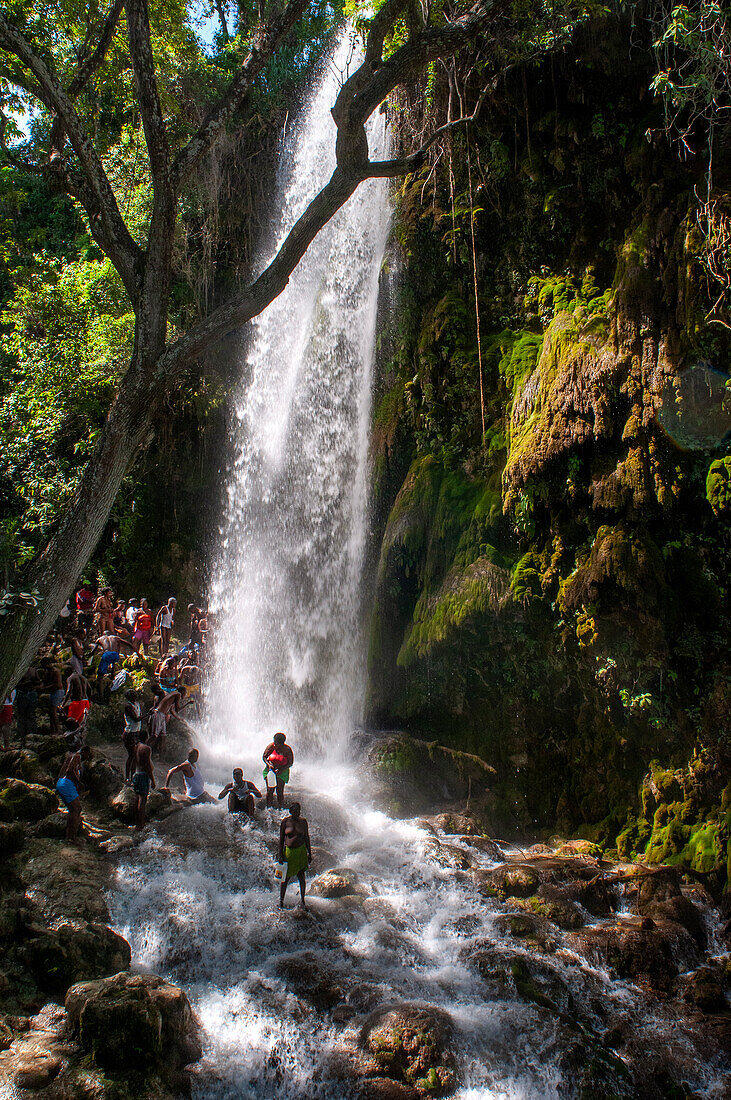 Haiti Voodoo Festival in Saut d'Eau, in Saut d'Eau, Ville Bonheur, Haiti. Thousands of both Vodou and Catholic followers gathered under the Saut d'Eau waterfall in Haiti. The pilgrimage, made by Voodou practitioners and Catholics alike, originated with the sighting of the likeness of the Virgin Mary on a palm leaf close to the falls half a century ago. Catholism and Voodou practices are forever intertwined in its Haitian form. The appearance of a rainbow beneath the falls is said indicate that Danbala - the great lord of the waterfall - and Ayida Wedo - the rainbow - are making love. Fertility