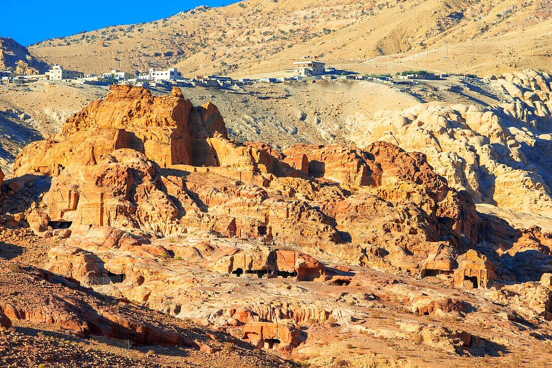 Ruine von Moghar Annassara (christliche Gräber) in Petra und das Dorf Uum Sayhoun im Hintergrund, Jordanien. Petra Luftaufnahme Perspektive der alten Höhlen und heiligen Gräber und im Hintergrund die neue Stadt Uum Sayhoun, Petra Jordanien