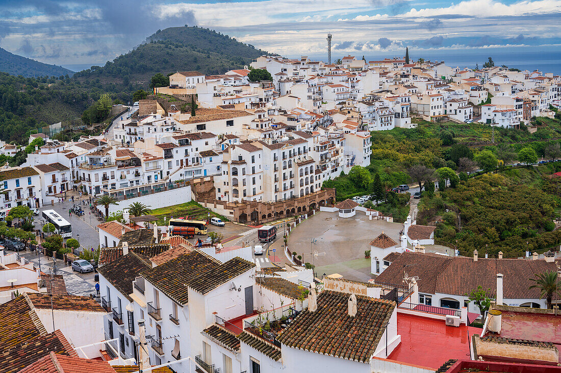 Colorful town of Frigiliana with whitewashed buildings set amidst lush scenic landscapes.