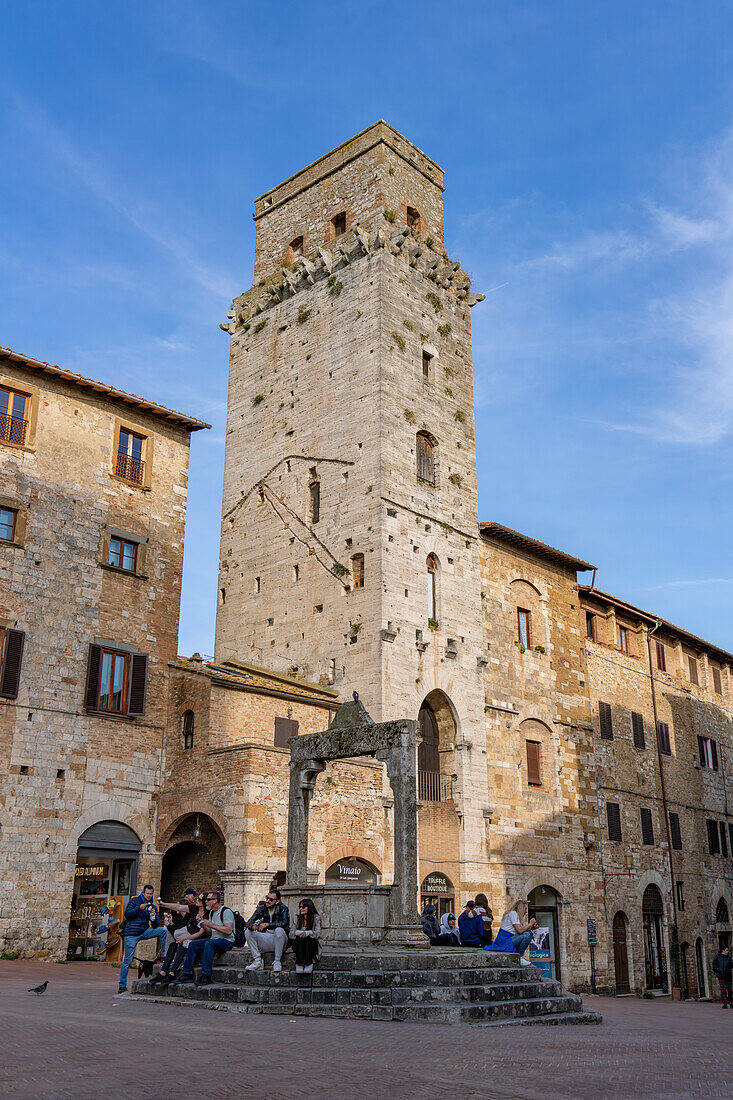 The Piazza della Cisterna & the Devil's Tower or Torre del Diavolo in the medieval city of San Gimignano, Italy.