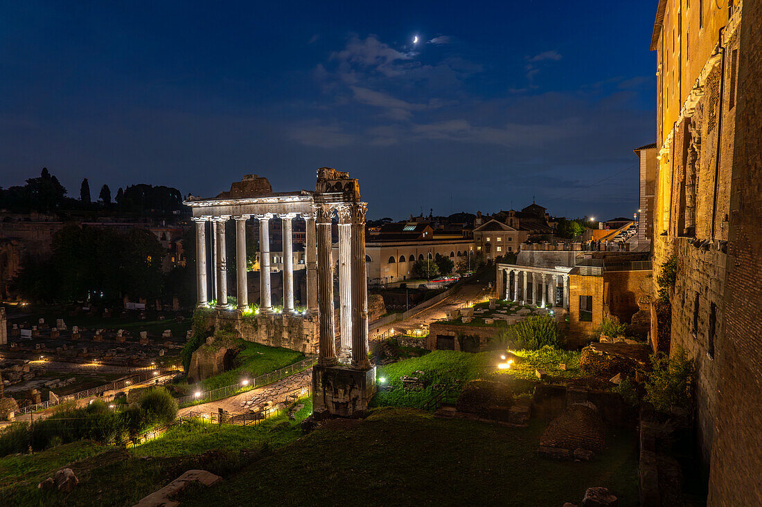 Temple of Vespasian and Titus with the Temple of Saturn behind in the ruins of the Roman Forum in Rome, Italy.