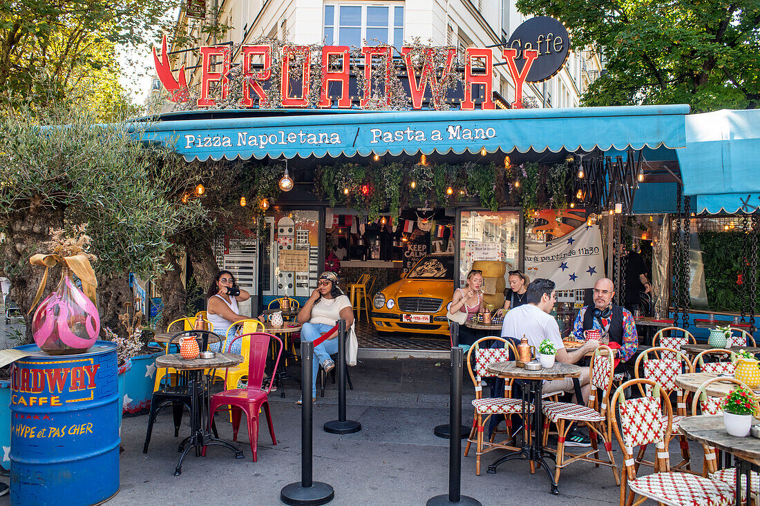 People sitting at Boadway cafe pizza restaurant on a street avenue in Montparnasse Paris France EU Europe