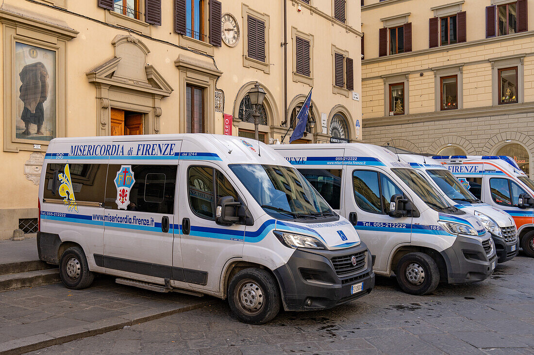 Emergency services ambulances parked on the edge of the Piazza del Duomo in Florence, Italy.