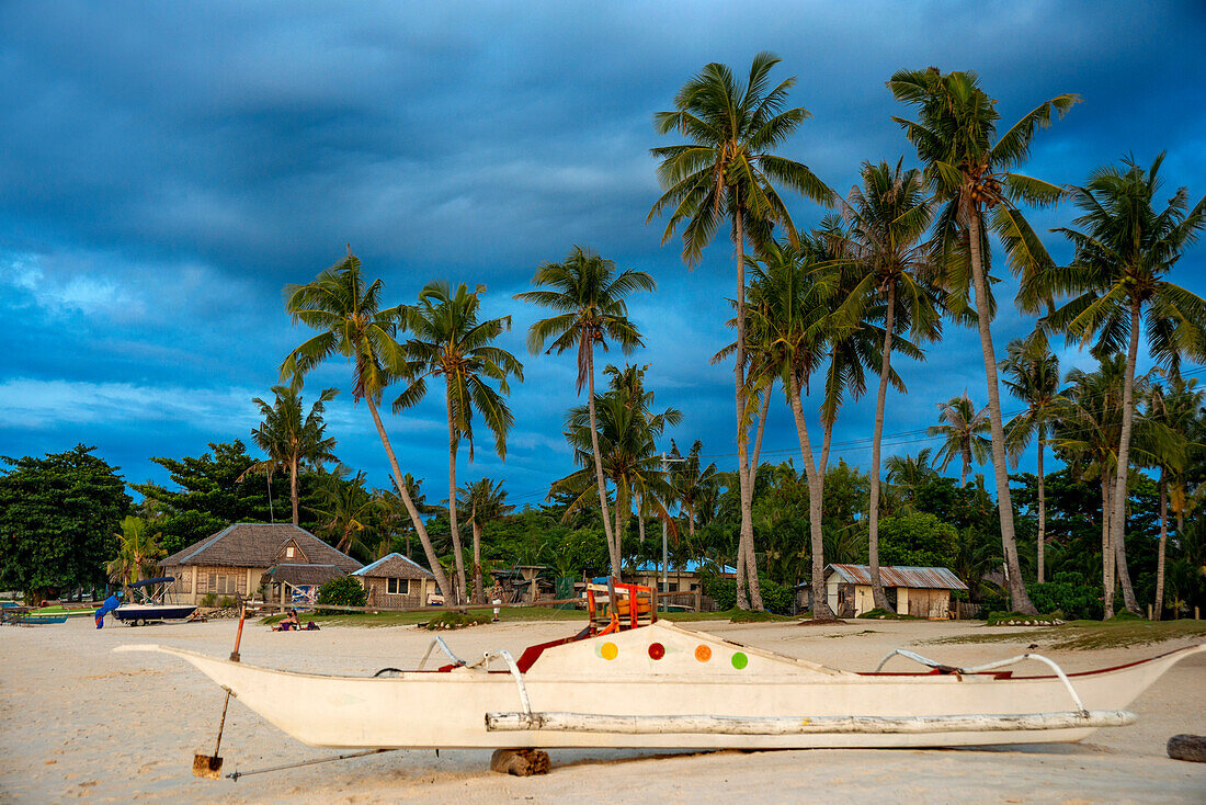 Local fish boats in white sand beach in of Langub Beach Malapascua island, Cebu, Philippines