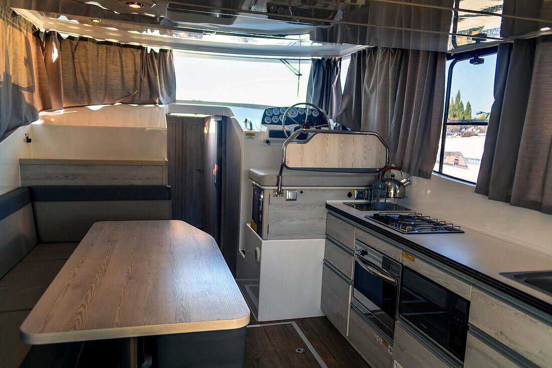 Kitchen inside a boat for a rent in the Canal of Midi trip on the river, France, Europe