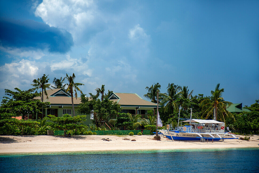 Hotels and boats in the first line of the beach Bounty beach, Malapascua island, Cebu, Philippines