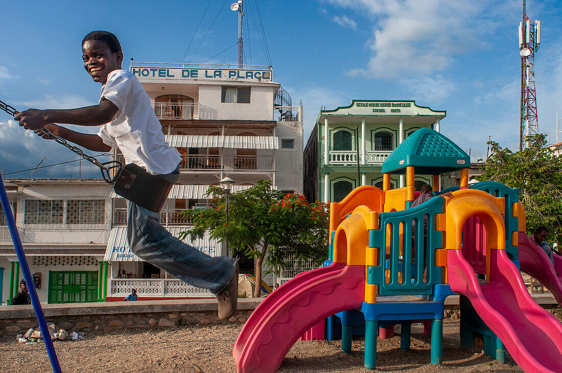 Chindren playing in the children's playground in Jacmel town square in Jacmel city center, Haiti