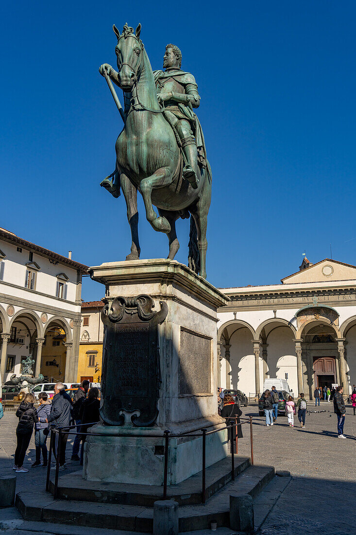 Equestrian statue of Grand Duke Ferdinando I de' Medici. Piazza Santissima Annunciata, Florence, Italy. Behind is the Basilica della Santissima Annunziata.