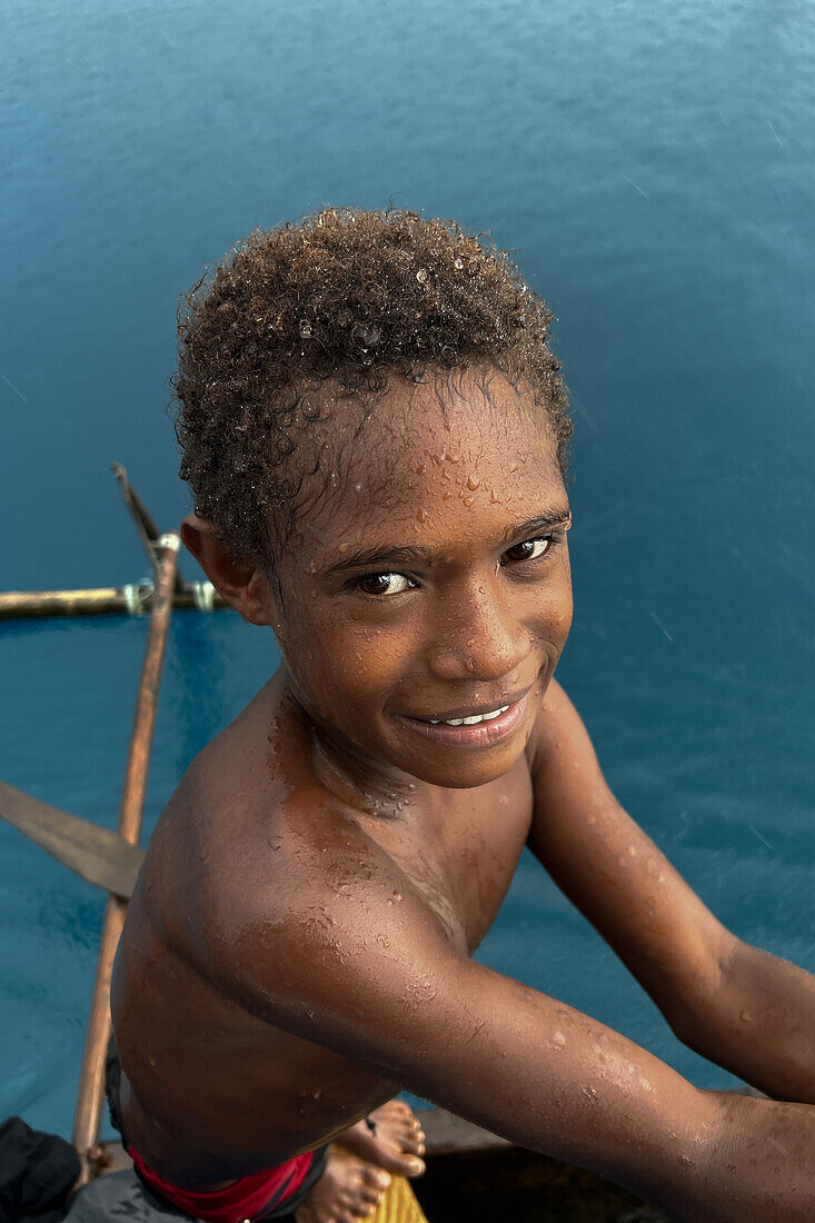 Residents of Tungelo Island in their traditional dugout canoes, New Ireland province, Papua New Guinea