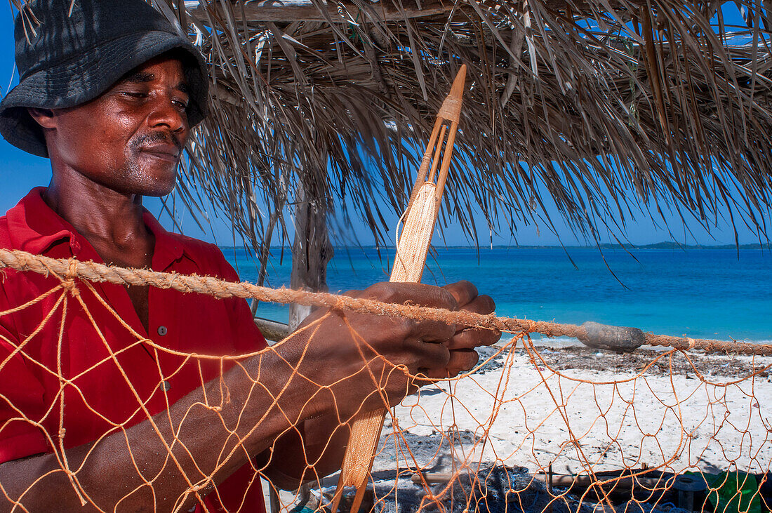 Fisherman fixing the nets in Cayes-à-L’eau, a fishermen islet located northeast of Caye Grand Gosie, Île-à-Vache, Sud Province, Haiti