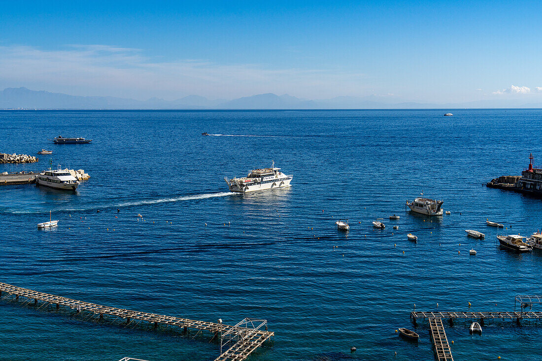 A commercial passenger ferry boat departs from the harbor of the town of Amalfi on the Amalfi Coast in Italy.