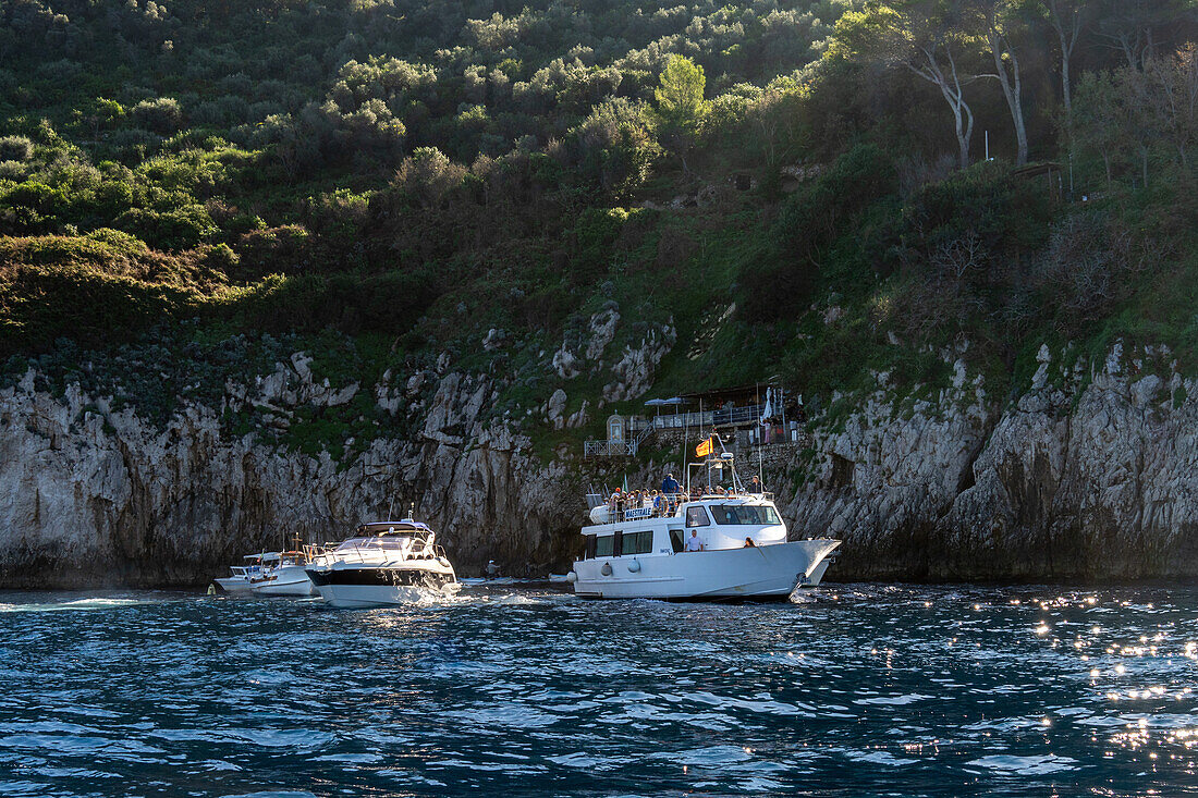 A tour boat traffic jam at the Blue Grotto on the island of Capri, Italy.