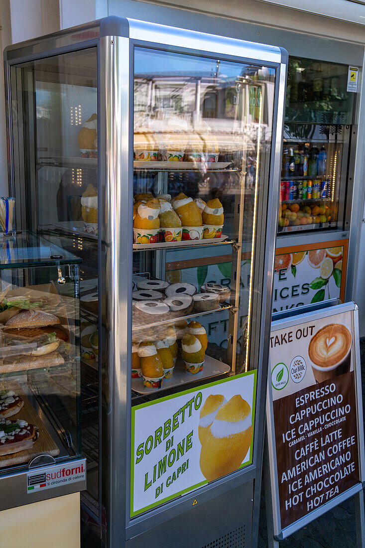 A freezer in a shop with coconut gelato and lemon sorbet for sale in Anacapri on Capri, Italy.