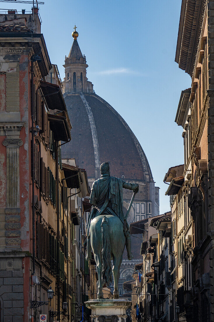 The statue of Grand Duke Fernando de Medici facing the dome of the Medici Chapel in Florence, Italy.