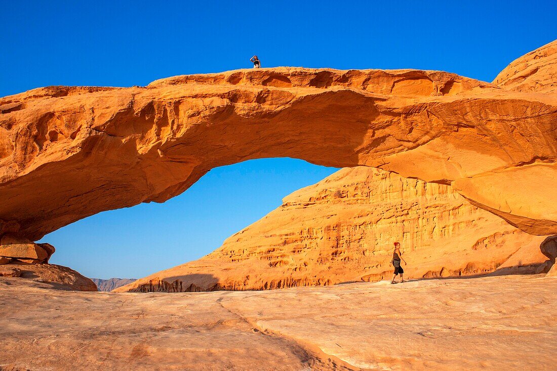 Hiking at rock-arch Al Kharza or Al Borg Alsagheer Wadi Rum, Jordan