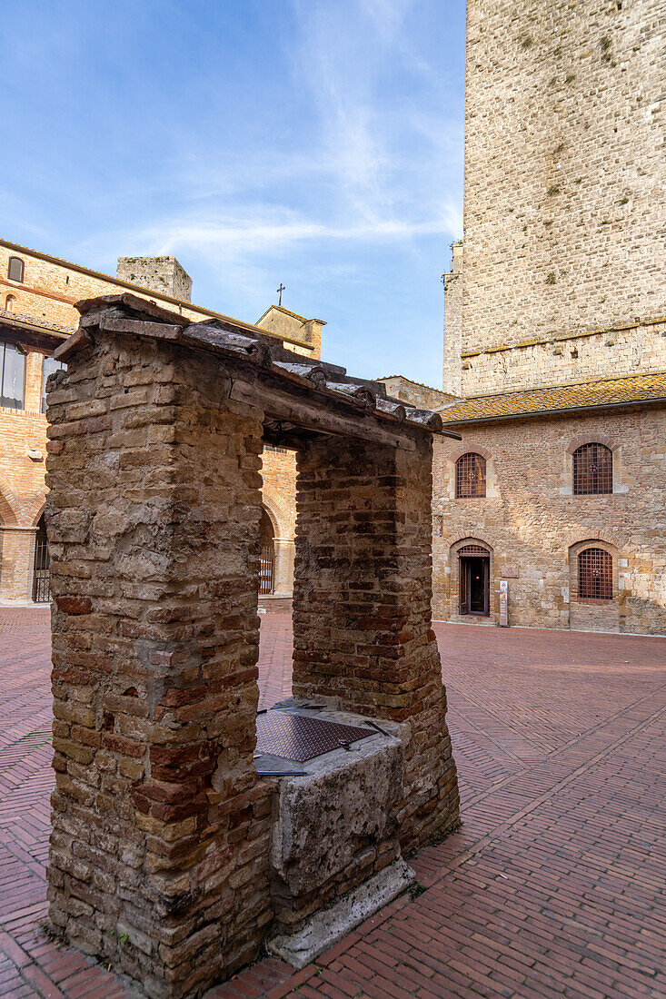 A well or cistern in the Piazza Pecori by the cathedral in the medieval walled town of San Gimignano, Italy.