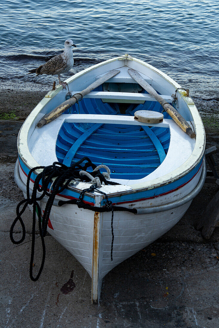 A wooden rowboat hauled out on the ramp in the Marina Grande harbor on the island of Capri, Italy.