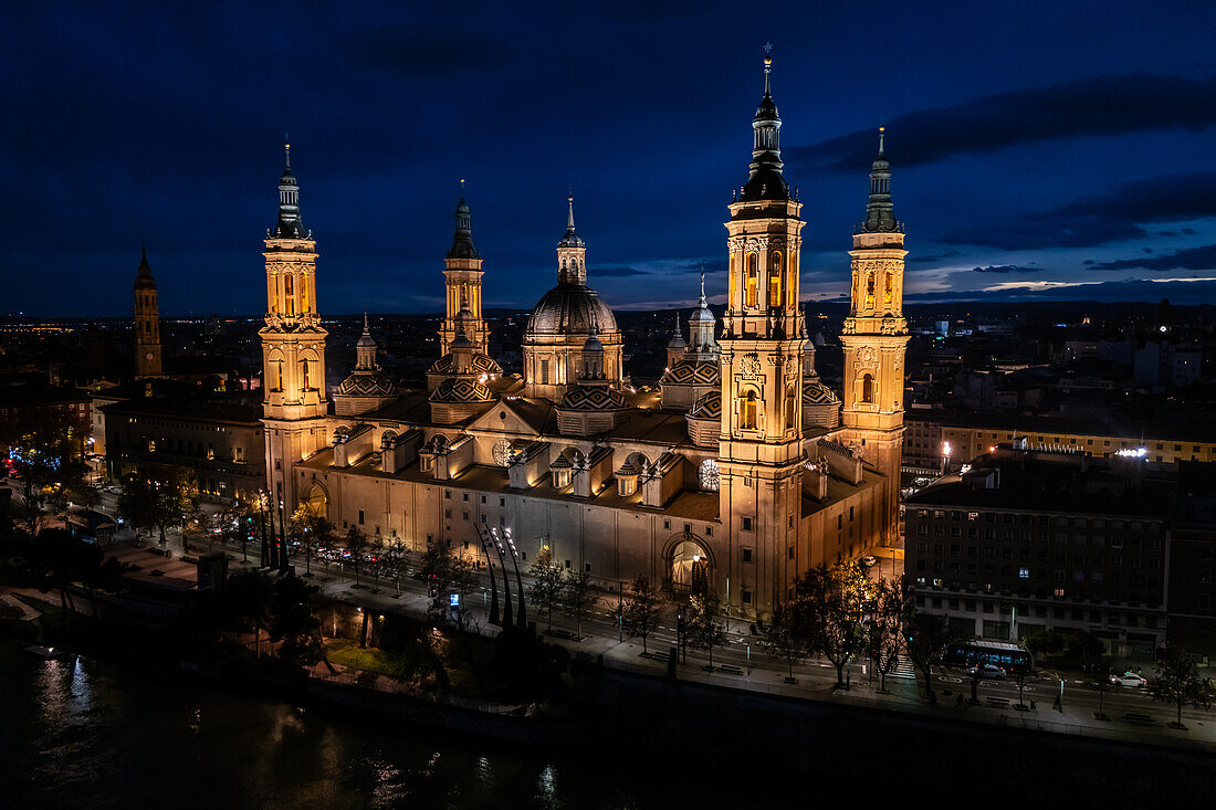 Aerial view of the Cathedral Basilica of Our Lady of the Pillar illuminated at night during Christmas, Zaragoza, Spain