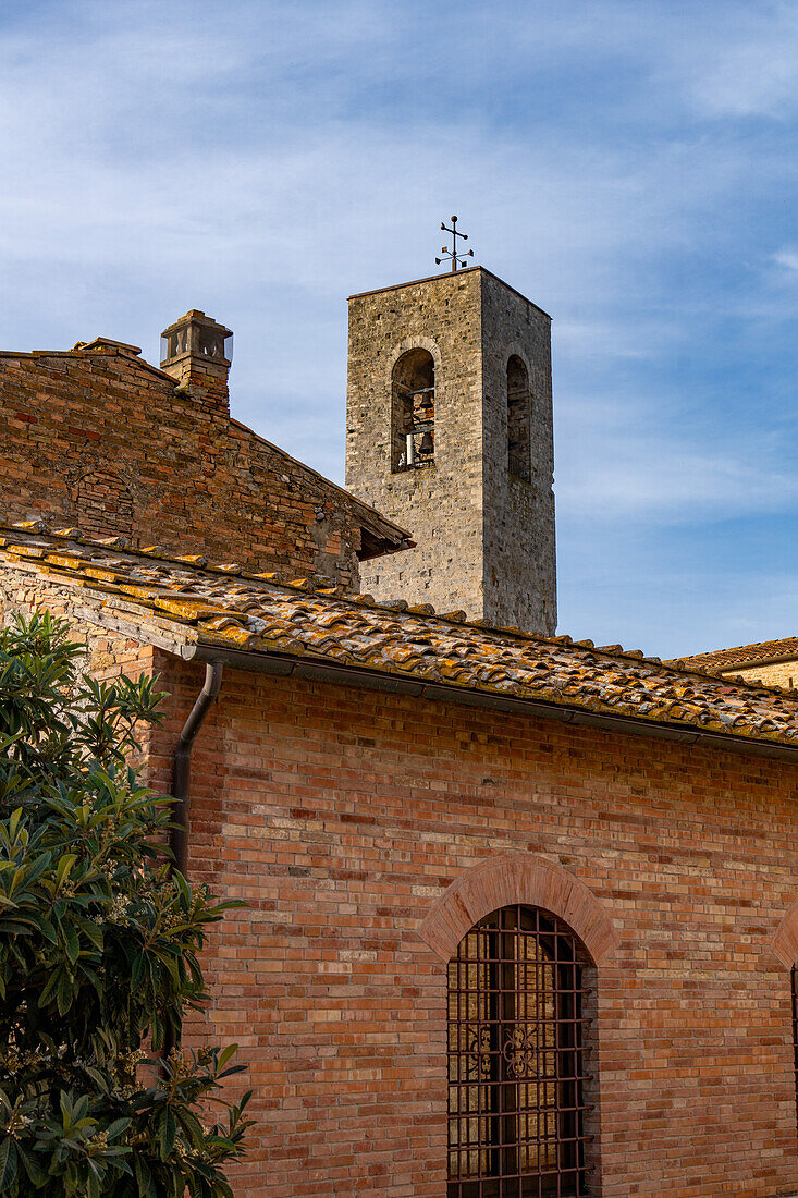 The campanile or bell tower of the Collegiata di Santa Maria Assunta in the medieval city of Gimignano, Italy.