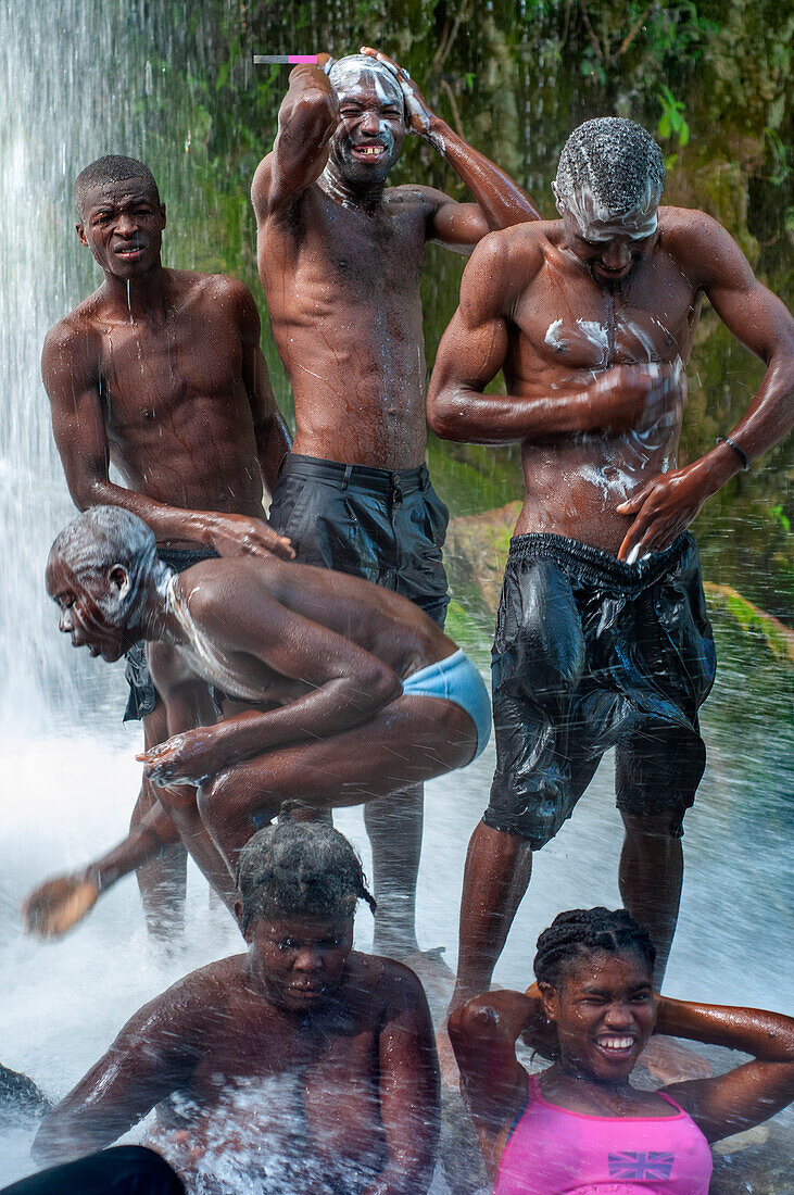 Haiti Voodoo Festival in Saut d'Eau, in Saut d'Eau, Ville Bonheur, Haiti. Thousands of both Vodou and Catholic followers gathered under the Saut d'Eau waterfall in Haiti. The pilgrimage, made by Voodou practitioners and Catholics alike, originated with the sighting of the likeness of the Virgin Mary on a palm leaf close to the falls half a century ago. Catholism and Voodou practices are forever intertwined in its Haitian form. The appearance of a rainbow beneath the falls is said indicate that Danbala - the great lord of the waterfall - and Ayida Wedo - the rainbow - are making love. Fertility