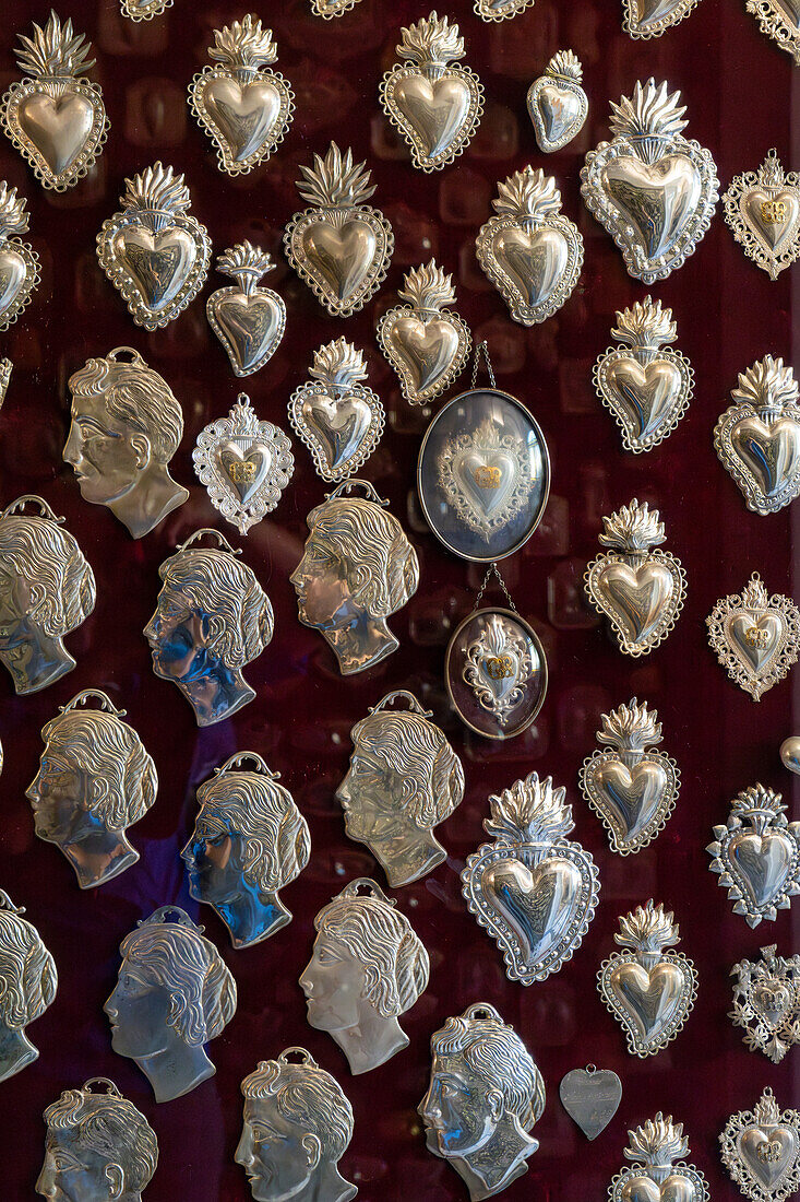 Silver talismen or offerings for blessings recieved in the crypt of the Basilica of Sant'Antonino, Sorrento, Italy.