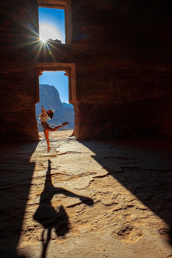 Dancing inside The Corinthian Tomb and the Palace Tomb of the Royal Tombs in the rock city of Petra. The Urn Tomb of the Royal Tombs in the rock city of Petra. Street of Facades, Tombs of Petra, Jordan.