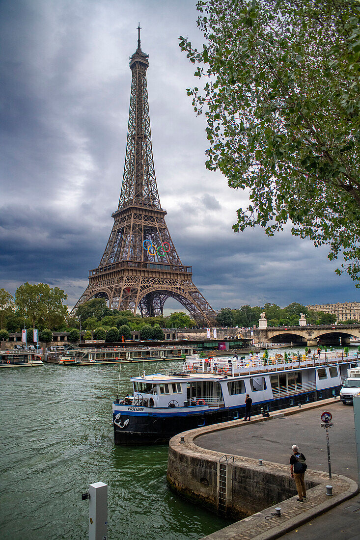 Passenger touristic cruise ship in the Seine river is moored to the pier near Eiffel Tower