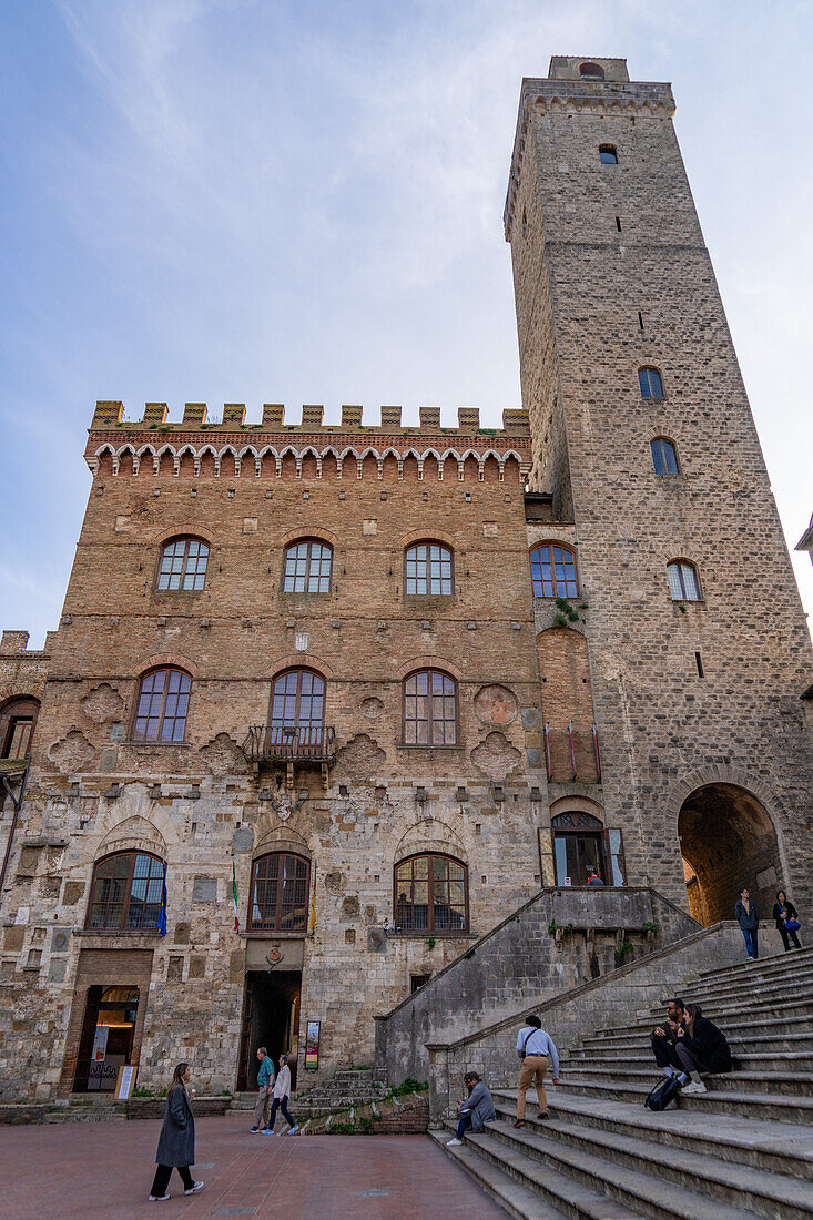 Facade & tower of the 13th Century Palazzo Comunale, Palazzo del Popolo or city hall in San Gimignano, Italy.