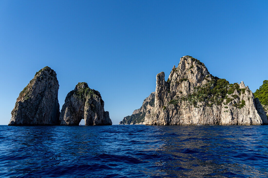 The Farallons or faraglioni, sea stacks off the coast of the island of Capri, Italy. L-R: Scopolo or Fuori, Mezzo with its sea arch & Stella.