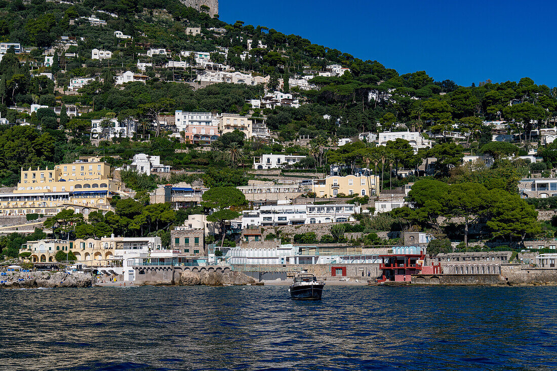 The seaside resort town of Marina Piccola by the Tyrrhenian Sea on the island of Capri, Italy. The large Hotel Weber Ambassador is at left.