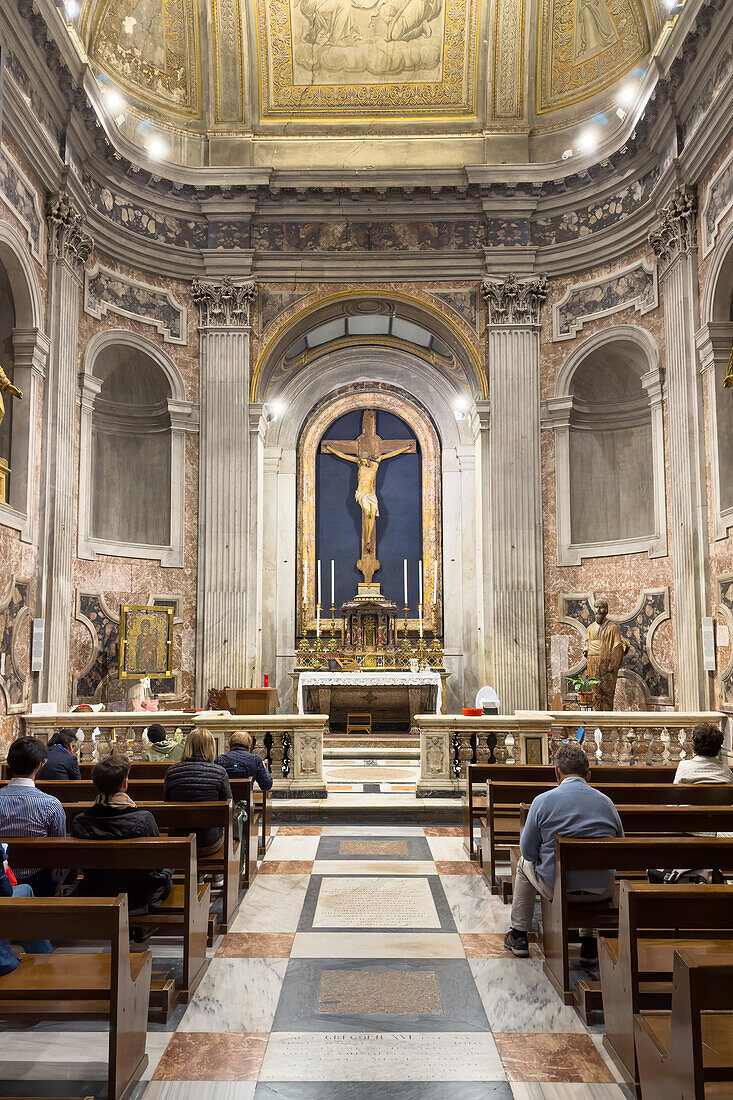 Worshippers in the Chapel of the Blessed Sacrament in the Basilica of St. Paul Outside the Walls, Rome, Italy.