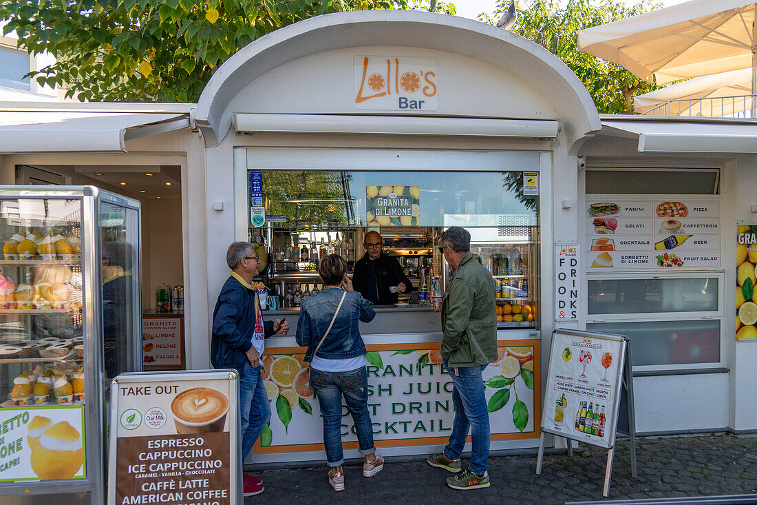 Tourists at a snack food stand on a square in Anacapri on the island of Capri, Italy.