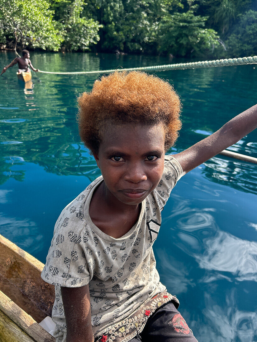 Residents of Vitu Islands in their traditional dugout canoes, Garove Island, Johann Albrecht Harbour, Papua New Guinea