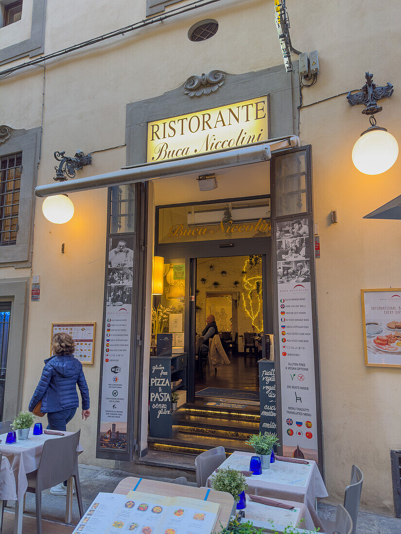 Doorway to a restaurant advertising gluten-free pizza and pasta in Florence, Italy.